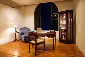 Seville Curio Cabinet and small table with Overstuffed armchairs